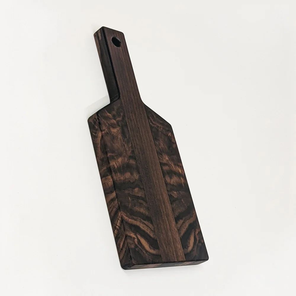 March 22nd, 2022: Our solid walnut paddle cutting board! Perfect for a little bit of charcuterie or cooking while camping. Each paddle has a beautiful, symmetrical grain pattern unique to each board. Get these paddles and more from the Put Together Store!